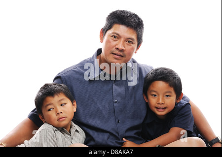 Asian father cuddles his two sons Stock Photo