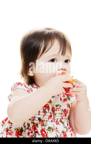 Infant girl tasting delicious apple for first time portrait Stock Photo
