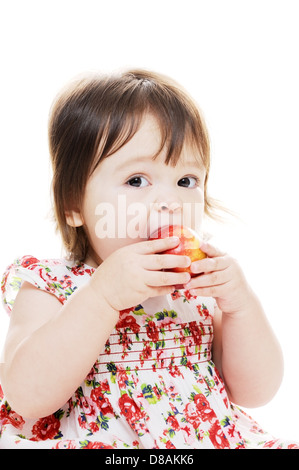 Little girl taking a big bite of red apple closeup portrait Stock Photo