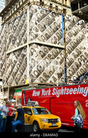 New York, USA. 21st May 2013.  Tourists in New York sightseeing bus can see a gigantic display of the Inside Out art project of large black and white self-portraits of New Yorkers, conceived by French artist JR, during a pleasant spring day in Manhattan. Credit:  Ann E Parry / Alamy Live News Stock Photo