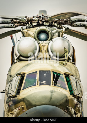 Focus on windows of cockpit and propeller of russian military helicopter, gray sky in background. Army air transport in Russia. Stock Photo