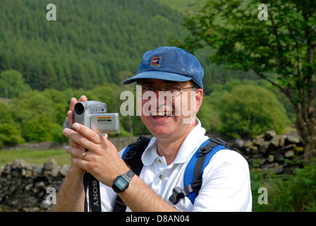 Middle aged man using camcorder in open air Stock Photo