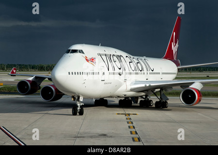 A Boeing 747 of Virgin Atlantic airways taxiing on to stand Stock Photo