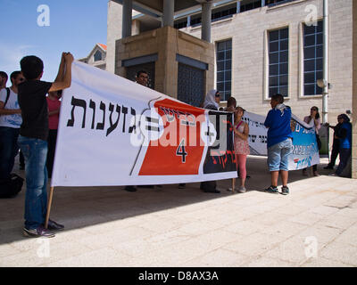 Jerusalem, Israel. 23rd May 2013. Protesting residents of Beit-Safafa demonstrate at City Hall against ongoing construction of Road 4, which they claim is a discriminatory act of racism. Sign reads in Hebrew: 'Nir Barkat (Jerusalem Mayor) + Road 4 = Racism'. Jerusalem, Israel. 23-May-2013.  Residents of the Arab village of Beit-Safafa, together with Jewish supporters, demonstrate at City Hall against ongoing construction of Road 4, which they claim, tears their village in two and is a discriminatory act of racism. Credit:  Nir Alon / Alamy Live News Stock Photo