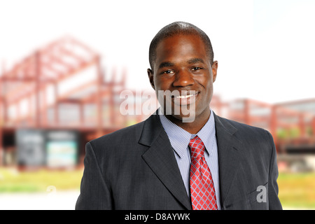 Young African American Businessman smiling with building construction on background Stock Photo