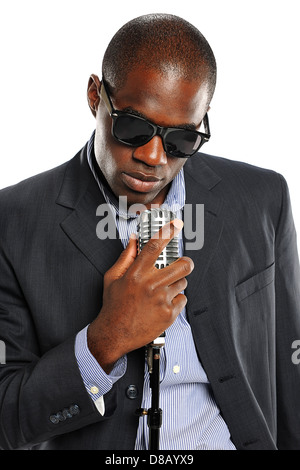 African American Singer holding a vintage microphone isolated on a white background Stock Photo