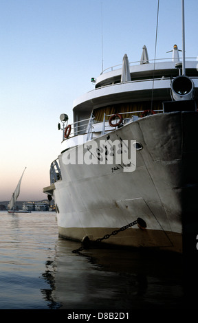 Cruise ship and Felucca at sunset on the river Nile in Aswan in Egypt. Stock Photo
