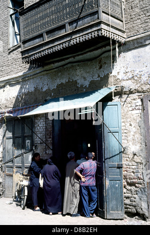 Locals line up for bread outside a bakery in the souks of Luxor in Egypt. Stock Photo