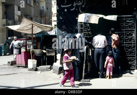 Locals line up for bread at a bakery in the souks of Luxor in Egypt. Stock Photo