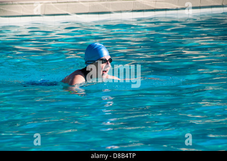 Woman swimming laps in pool Stock Photo