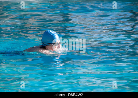 Woman swimming laps in pool Stock Photo