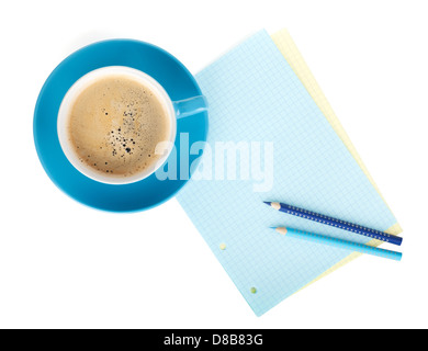 Blue coffee cup, blank paper and two pencils. View from above. Isolated on white background Stock Photo