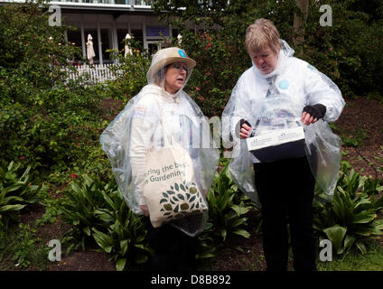 London, UK. 24th May 2013. Staff braving the cold and wet weather conditions at the Chelsea Flower Show.  Photographer: Gordon Scammell/Alamy Live News Stock Photo