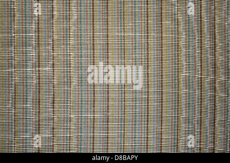 This stock photo shows a close-up of brown and blue striped upholstery fabric. The texture and colors highlight the fabric’s woven design, making it suitable for furniture and interior decor. The contrasting stripes add visual interest and elegance to the material. Stock Photo