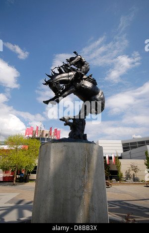 The 'Bronc Twister' a bronze by Rich Roenisch at the entrance to the Calgary Stampede, based on a 1919 drawing by Edward Borein Stock Photo