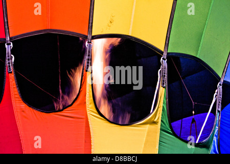 Closeup on stream of fire in interior of rainbow-paneled hot air balloon in Boise, Idaho Stock Photo