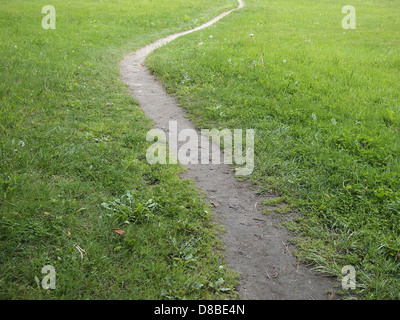 A well trodden winding dirt path through grass, New York, USA, May 22, 2013, © Katharine Andriotis Stock Photo