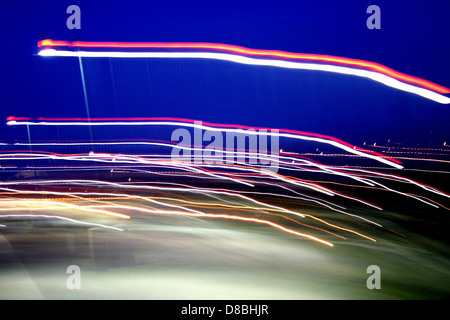 The image features open shutter lights, creating a blurred, dynamic effect. This technique captures the movement of light, commonly used in photography to create artistic visuals with a sense of motion and energy. Stock Photo