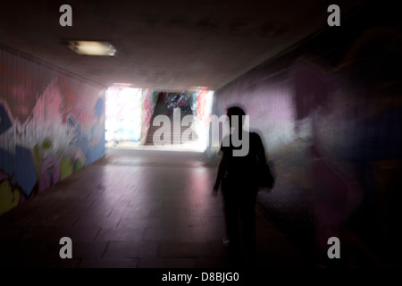 A man walking in a dark tunnel with graffiti, symbolic image for panic, Trier, Rhineland-Palatinate, Germany, Europe
