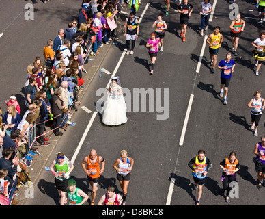 London marathon 2013 competitors including one in a wedding dress on Victoria Embankment England Europe Stock Photo