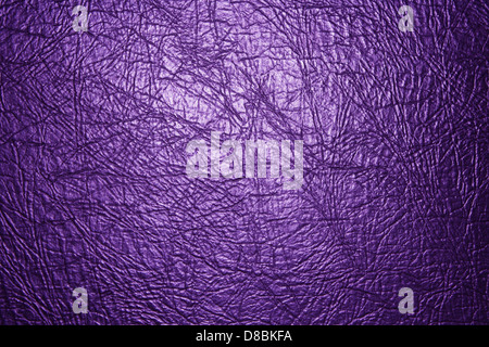 A close-up of purple leather showcasing its smooth texture, creases, and sheen. The image highlights the fine grain and quality of the material. Stock Photo