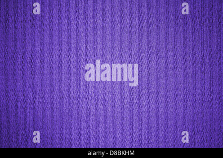A close-up image of a purple ribbed knit texture, showcasing the intricate weaving and fabric pattern. The texture is soft yet durable, commonly used in fashion for sweaters, scarves, and other garments. Stock Photo