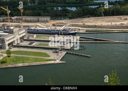 Belgium. Barges sail through a canal lock at the Albert canal, viewed from Fort Eben Emael Stock Photo