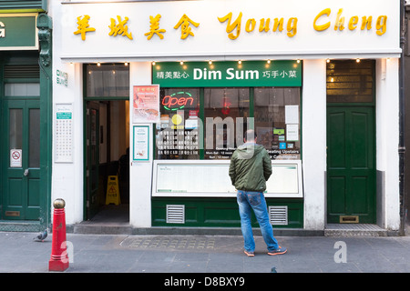 Man outside Chinese restaurant in china town london Stock Photo