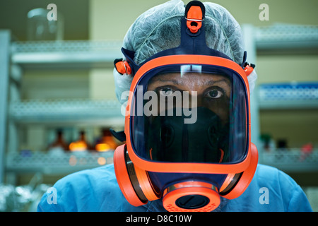 Medicine and science, and pharmaceutical laboratory with scientist wearing mask and looking at camera Stock Photo