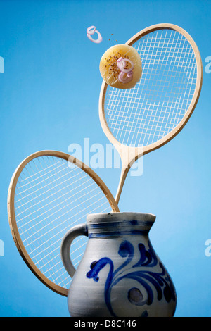 Flying handkaese with badminton racket and jug Stock Photo