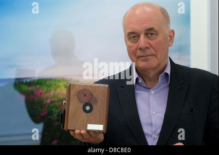 Actor Hanns Zischler stands in his exhibition holding a pin-hole camera in Berlin, Germany, 24 May 2013. The Alfred Ehrhardt Foundation is exhibiting Zischler's unusually poetic landscape pictures that he has been taking since the 1990's. Photo: MAURIZIO GAMBARINI Stock Photo