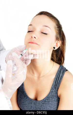 Beautiful young woman getting lip injection, botox or collagen Stock Photo