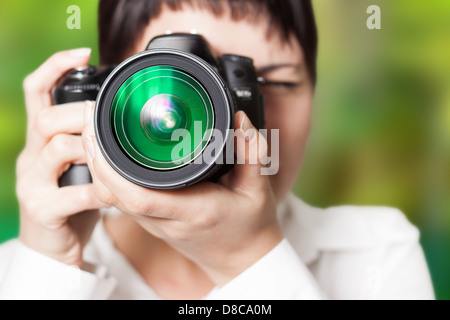 Pretty woman is a professional photographer with dslr camera Stock Photo