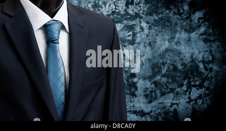 man in suit on a concrete wall background Stock Photo