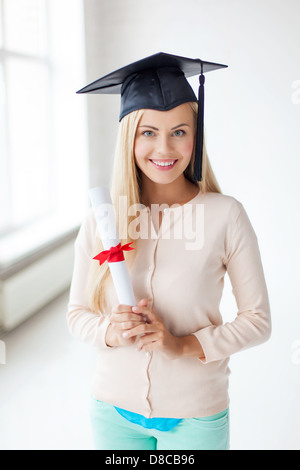 student in graduation cap with certificate Stock Photo