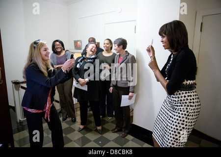 US First Lady Michelle Obama poses with a Flat Stanley cutout as Kelly McMahon takes her picture backstage at the Department of the Interior April 23, 2013 in Washington, DC. Watching nearby, from left, are: Danielle Gray, Cabinet Secretary; Tina Tchen, the First Lady’s Chief of Staff; Kristen Jarvis, Deputy Director of Advance & Traveling Aide for the First Lady; and Secretary of the Interior Sally Jewell. Stock Photo
