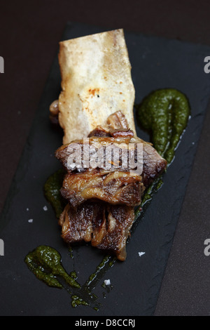 Slow cooked shortribs with green mojo is served at Ibérica La Terraza in London. Stock Photo