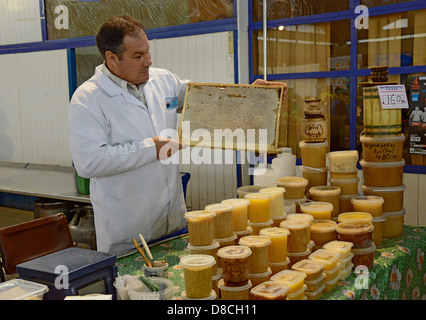 Honey seller with honeycomb frame. Noviy Rynok (New Market) in Barnaul. Honey trading. Siberia. Russia Stock Photo