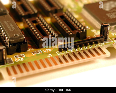 This image displays the intricate components of a computer mainboard (motherboard). The mainboard is the central component that connects and allows communication between various hardware components of a computer. Stock Photo