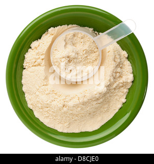 whey protein powder in a small ceramic bowl with a plastic scoop Stock Photo