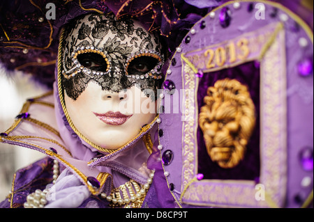 A 2013 Carnival of Venice participant wearing a purple mask and costume, Venice, Italy. Stock Photo