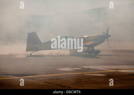 airplane in smoke on the ground Stock Photo