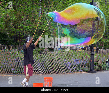 Man in Washington Square Park in New York City blowing large bubbles. Stock Photo