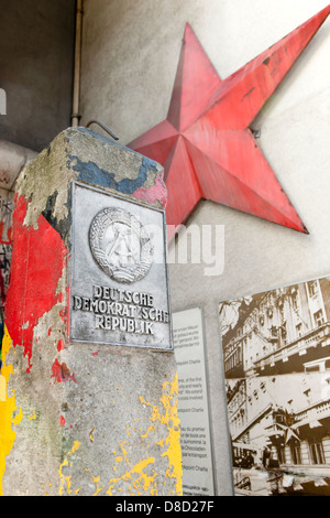 A piece of the Berlin wall with The German Democratic Republic Coat of arms Stock Photo