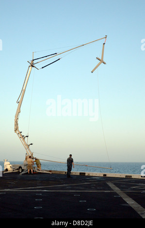 A US Navy Scan Eagle Unmanned Aircraft System aircraft is retrieved on board the amphibious transport dock ship USS San Antonio during training exercises the International Mine Countermeasures Exercises May 14, 2013 in the Arabian Sea. Stock Photo