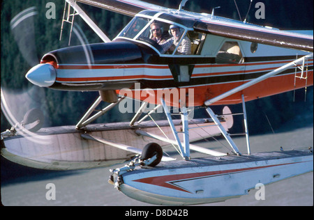 A pilot and co-pilot operate an aircraft, working together in the cockpit. The image highlights the teamwork and focus required to fly the plane safely, as they monitor instruments and communicate during the flight. Stock Photo