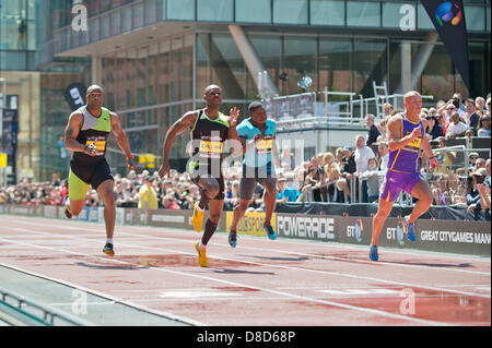 MANCHESTER, UK. 25th May 2013. Kim Collins (second left) of Saint Kitts and Nevis sprints to take 1st place during the Mens 100m event in a time of 10.26 which took place on Deansgate in Manchester during the 2013 BT Great CityGames. The former 100m World Champion beat Richard Kilty (Great Britain, 2nd, furthest right), Mark Lewis-Francis (Great Britain, 3rd, furthest left) and Harry Aikines-Aryeetey (Great Britain, 4th, second right). Credit: News Shots North/Alamy Live News (Editorial use only). Stock Photo