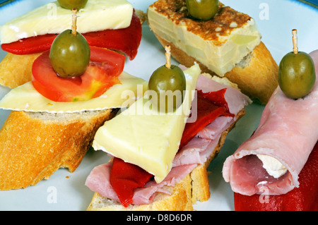 Spanish tapas selection including ham, cheese, tortilla, tomato and green olive, Andalusia, Spain. Stock Photo