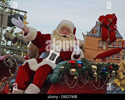 This image features Santa Claus, the iconic figure associated with Christmas. He is depicted in traditional attire, including a red suit, white beard, and black boots, often seen during holiday celebrations and parades. Stock Photo