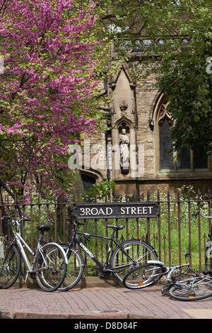 bikes leant against railings in Broad Street at Oxford in May